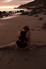 Red Hair Gal Doing Splits On Beach At Sunset