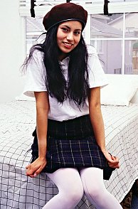 Latina Teen School Girl Sitting On Bed